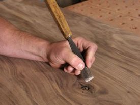 Chipping bad wood out of a knot