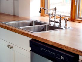 Face Grain Reclaimed Longleaf Pine countertop with drop in sink and Waterlox finish
