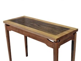 Custom hall table with a Texas Pecan framed Zebrawood floating top.
