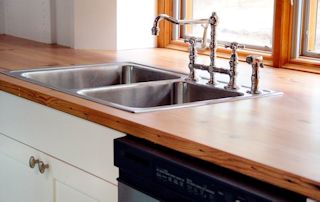 Face Grain Reclaimed Longleaf Pine countertop with drop in sink and Waterlox finish