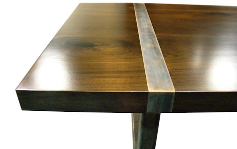 Custom dining table using book-matched walnut slabs with a drop edge for the top.  Custom steel base and accent bands with a hand rubbed (bronze) finish.